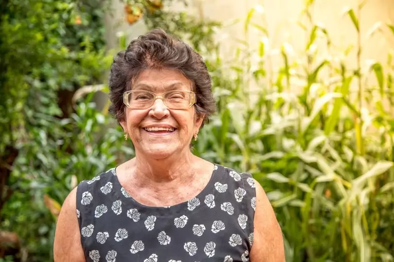 Breathe improved Emma A.'s life, portrayed smiling in a floral dress with glasses.