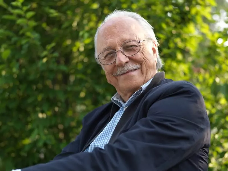 Breathe changed Carl J.'s breathing, shown as a joyful older man outdoors in a suit.